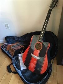 Esteban "Camaro" electric/acoustic metal string guitar. Includes authenticity certificate, 10x DVD instructional videos, original case. Has detailed image of Chevy Camaro on back and "ESTEBAN" in large letters. Excellent condition.
