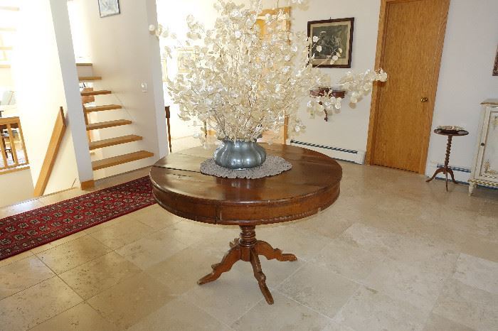 Antique round entrance hall table with antique pewter vase