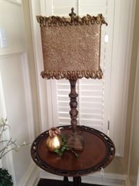 One of two matching round top side tables; unique lamp