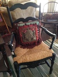 One of a pair of black wood rush seat chairs; another "Gipson Girl"  (precious Tyler antique store) decoraative pillow