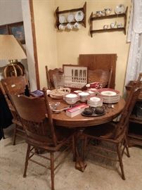 Oak dining room table, 5 chairs, and 2 ft leaf, silver plate, nice dishes, cups and saucers