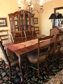 Beautiful dining table, with leaf extension. Seats 8. Two host chairs, 6 side chairs.