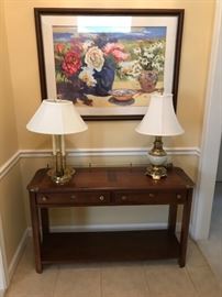 Entry hall piece. Large framed floral art. Lamps.