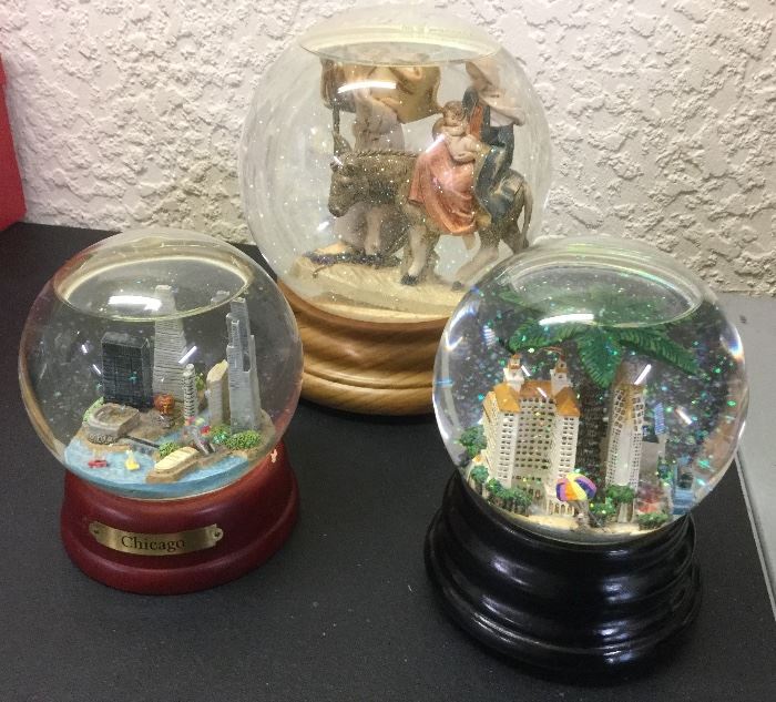 Snow globes: Chicago skyline, another of Naples, oversize globe of Holy Family 