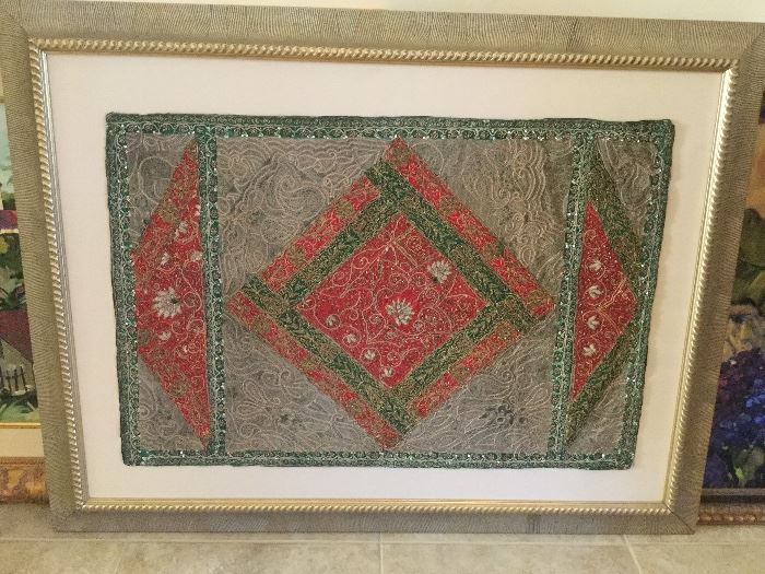 Artwork of Salma fabric Jari embroidery done with red, green, taupe, & metallic silver threads in filigree & floral design, set on ivory linen, ornate gold frame
