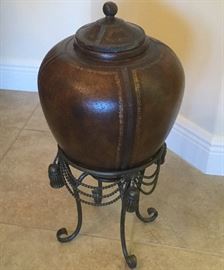 Brown leather with gilt trim ginger jar, peaked-shape bottom set in decorative aged brass holder