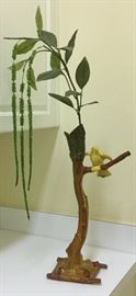 Hand-made original ceramic art,  of yellow bird perched on tree limb, green leaves forming a small vase at top to accommodate floral arrangement 