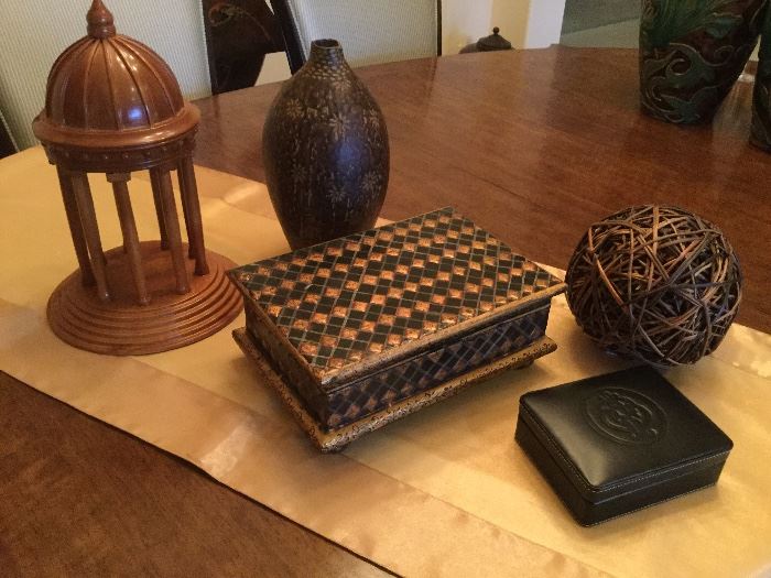 Accessories to love...wooden architectural model with steps, columns, and dome, 6 inch round twig ball, wooden box with hinged top, black and gold diamond pattern, black leather box with embossed design on top, bulbous shaped brown finish pottery vase, impressed flowers and etched lines at base