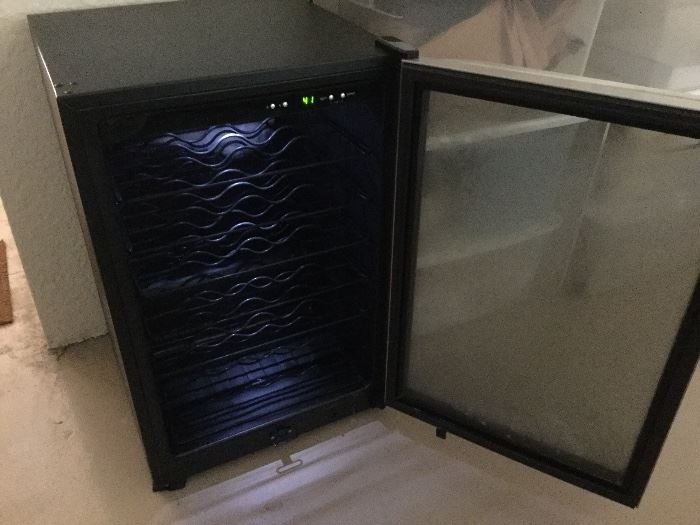 Frigidaire wine cooler with adjustable temperature settings, glass door, interior light