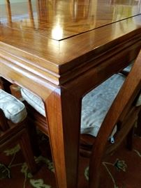 Beautiful hardwood (rosewood) dining table with 8 chairs and two leaves.  Far Eastern Furnishings Co. Hong Kong.  Series R.  Table w/o leaves 58".  Each leaf is 18".  42" wide and 30" high.  