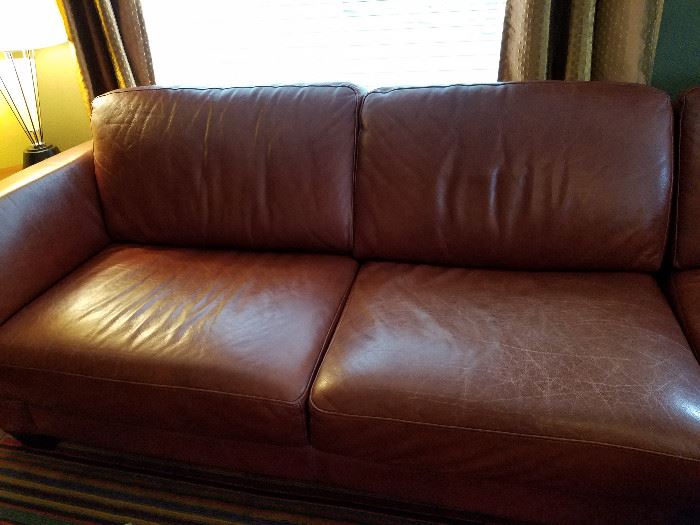 Italian leather sectional sofa made by Divani Chateau d'Ax.  Two pieces.  All cushions are attached to prevent sliding.  27" high, 107" long across back, 95" across to ottoman.  