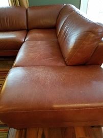 Italian leather sectional sofa made by Divani Chateau d'Ax.  Two pieces.  All cushions are attached to prevent sliding.  27" high, 107" long across back, 95" across to ottoman.  