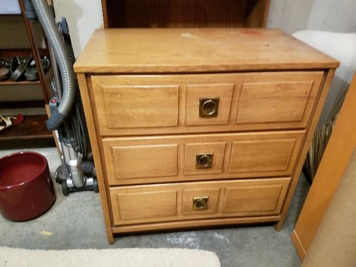No maker.  Three drawer wood dresser.  Some stains on top