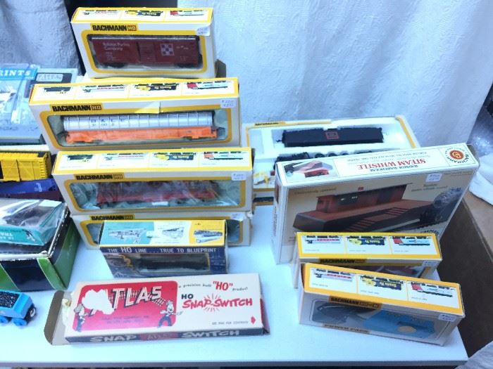 Model trains and accessories in boxes.