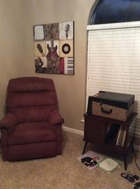 Mid century phonograph and MCM wood record album stand with sliding doors and brass foot accents.  Variety of vintage records in inspirational and easy listening titles. La-z-boy recliner. #MCM #records #cratedigger 