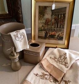 Bath towels with embroidery and fringe accents. Waste can, soap dispenser and tissue cover.