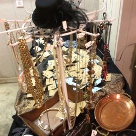 Black felted fascinator with feather trim. Neckwear fashions.