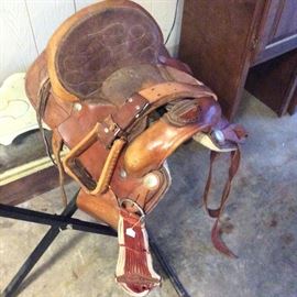 Leather saddle in warm cognac and brown shades with intricate hand tooled detailing. For farm, parade or even display use.