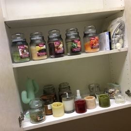 Scented candles in scents from sweet and light to heady.  Woodwick and Pier One, Better Home’s brands. Kitsch cactus candle. Tea lights.