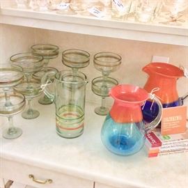 Margarita barware, including blown glass pitchers and footed glasses.