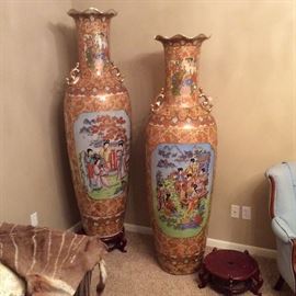 Exquisite Asian floor vases show figural painted scenes. Six feet in height, each has a fluted opening and comes with its own curved lacquer encrusted riser.
