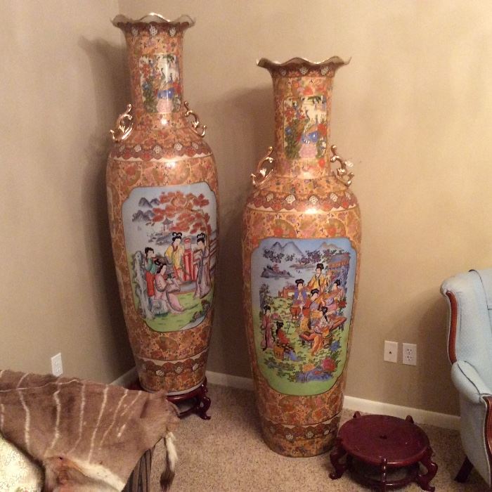 Exquisite Asian floor vases show figural painted scenes. Six feet in height, each has a fluted opening and comes with its own curved lacquer encrusted riser.