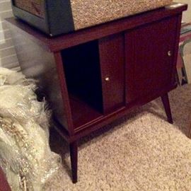 Record cabinet with 50s metal tipped legs. MCM portable record player. Vintage records include scarce Christian and easy listening titles. Custom Christmas wreaths. Icicle lights