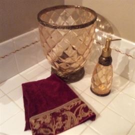 Bathroom decor: diamond pattern waste and soap dispenser. Embroidery trimmed towels.