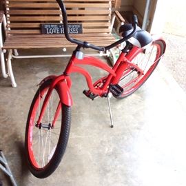 Mango Cruise bicycle in vivid red with black accents.