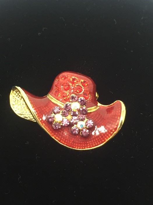 Small red hat pin with rhinestones.