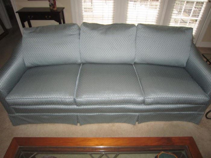 One of a pair of blue sofas