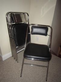 4 chrome and black faux leather folding chairs