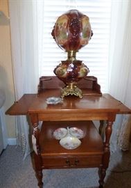Vintage cherry side table with slide-out sides, antique electrified oil lamp by Consolidated with embossed lions on shades