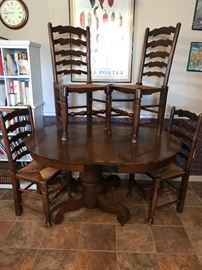 Very heavy antique oak table, includes 3 leaves (one leaf is shown) and 4 chairs.  Table is on wheels for easy moving.