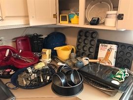 Several unique cookie cutters and other cooking utensils.