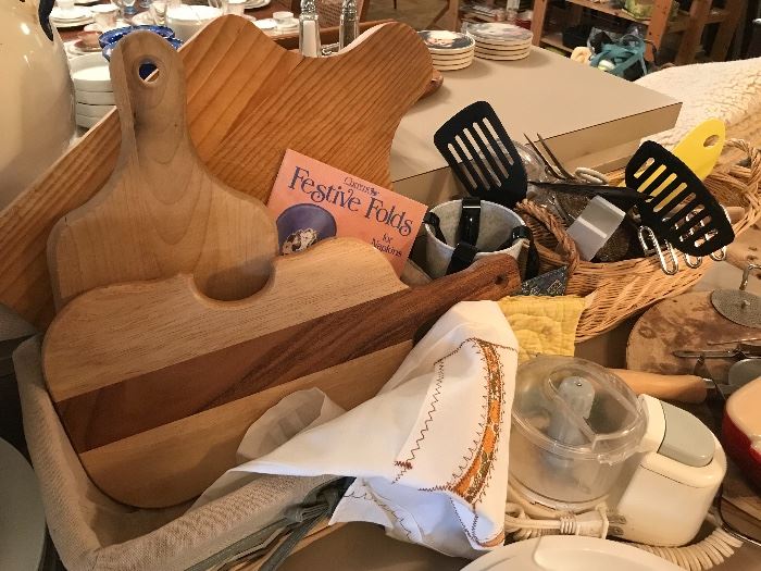 Several cutting boards and lots of various utensils.