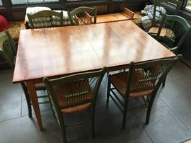 Dining table and 8 rattan and wood chairs all from Eddie Bauer Home. Table has two 18 inch leaves.  Chairs sold separately.  Table is 56"l without either of the two 15" leaves that extend it up to 92" long, it is 38"w x 29.5"high.  Asking $380 Chairs - 9 of them asking $540.