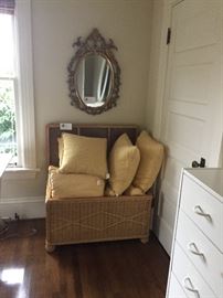 wicker trunk pillows and gilded mirror