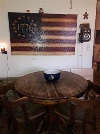 Oak table with pedestal that has claw feet on the bottom with two chairs