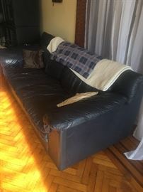 Comfy, well loved blue leather couch. Man cave style!