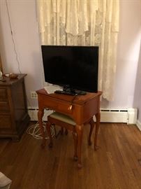 2 of 2 Samsung TVs on top of. I rage sewing table with bench