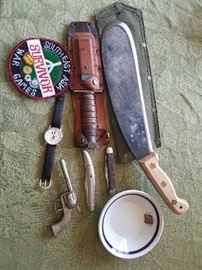 Pilot survival knife, Air Force patch, Machete, Hubley toy pistol, Mickey Mouse watch, Canadian Railroad Dish