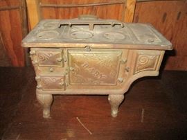 Miniature cast-iron stove with the word baby on the front of the stove