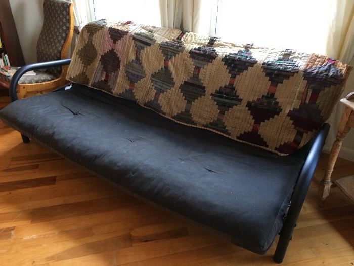 Futon upon which is displayed quilt shown in another photo