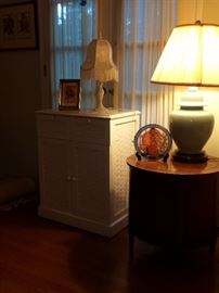 Lamps, round side table and wicker cabinet