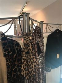 Several Leopard Print Pillows And Dresses / Tops