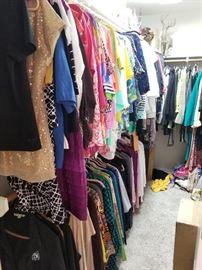 Several walk in closets full of designer clothes