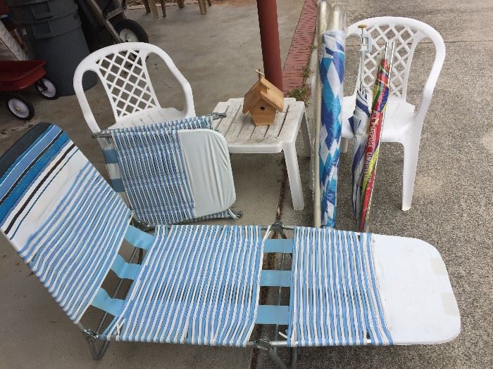 Beach chairs, umbrella, plastic chairs and plastic table