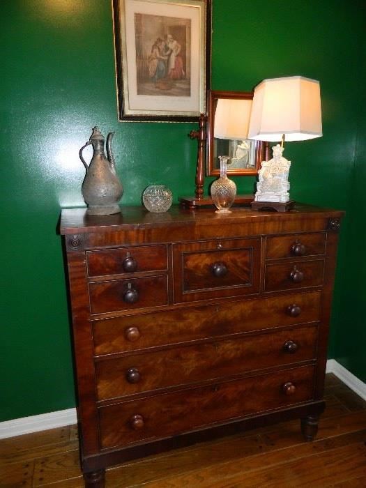 Antique mahogany chest with original pulls and escutcheons.  Turned legs.