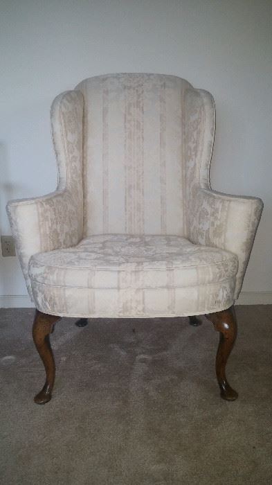 Circa 1710 English Queen Anne walnut wing chair with boldish shape frame & scrolled arms, the seat front bowed, on cabriole legs and pad feet at the front & back. Purchased in 1978